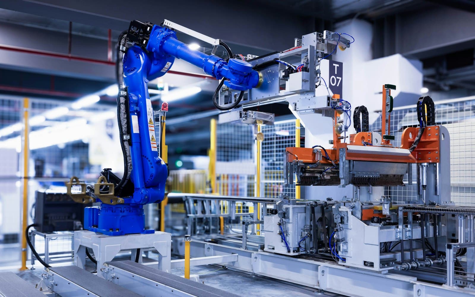 A robotic arm on a factory floor, representing Acer Labs's manufacturing operations