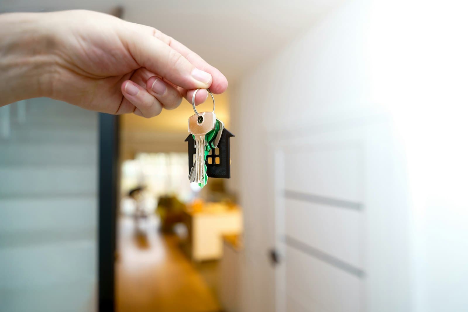 Handing over house keys at a property entrance, representing a completed Radius sale