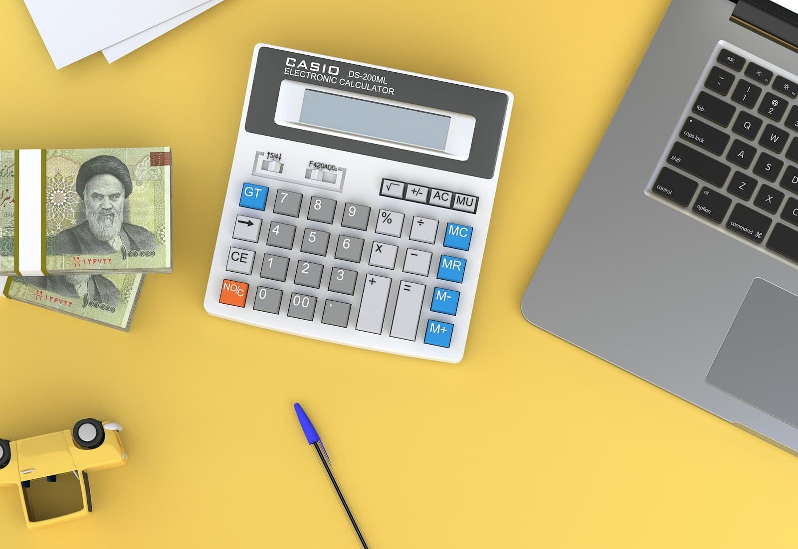 A calculator and laptop on a desk, representing loan repayment planning