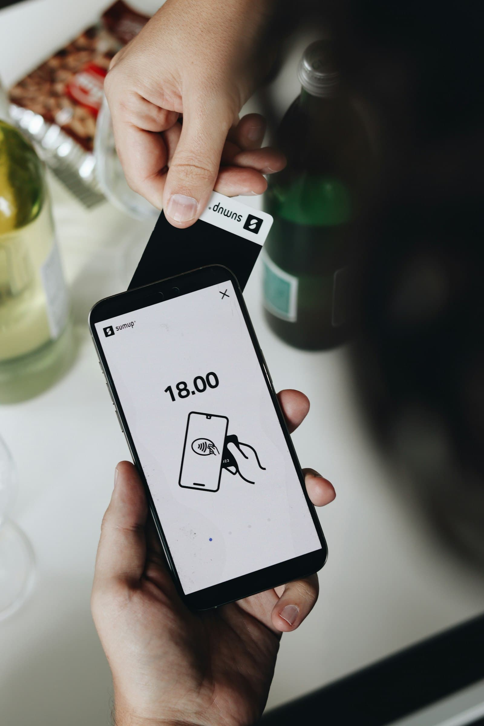 A person checking a transaction alert on their smartphone