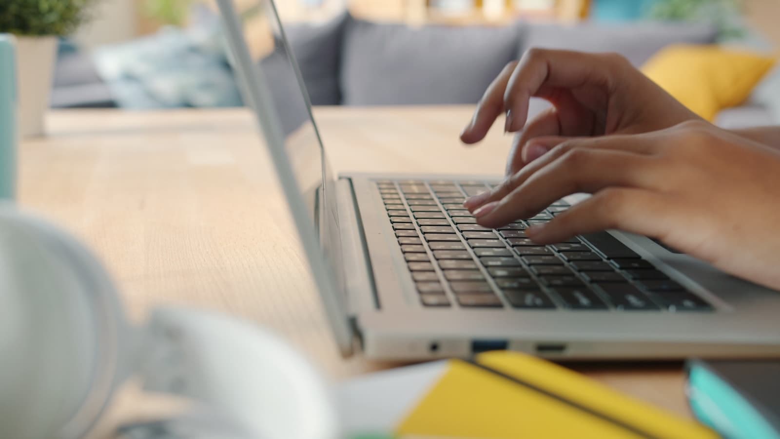 Hands typing on a laptop, representing a new customer completing account setup
