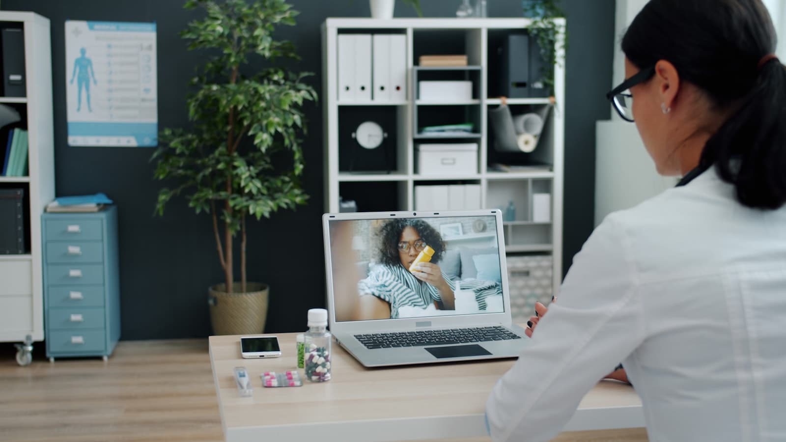 A doctor consulting a patient over video call, representing Teleopedia's virtual care platform
